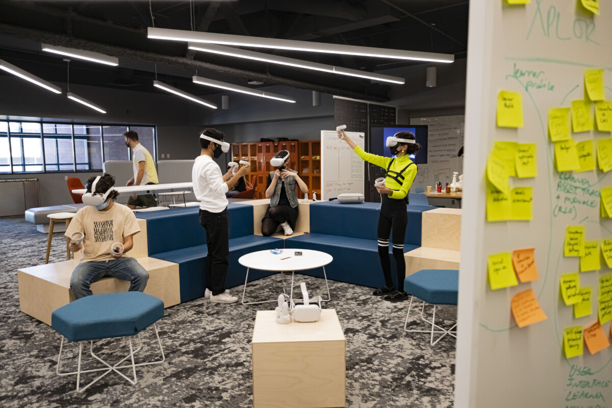 A group of people using VR technology at the Next Lab.