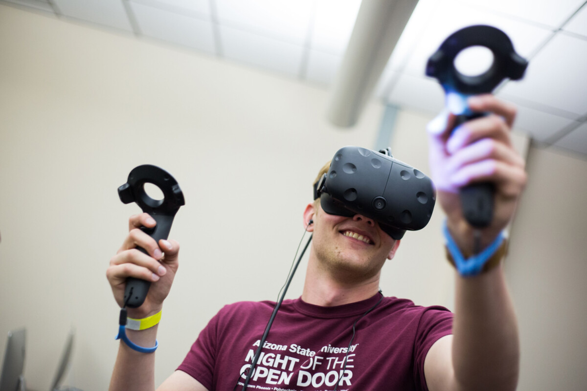 A man engaging with a VR headset and controllers.